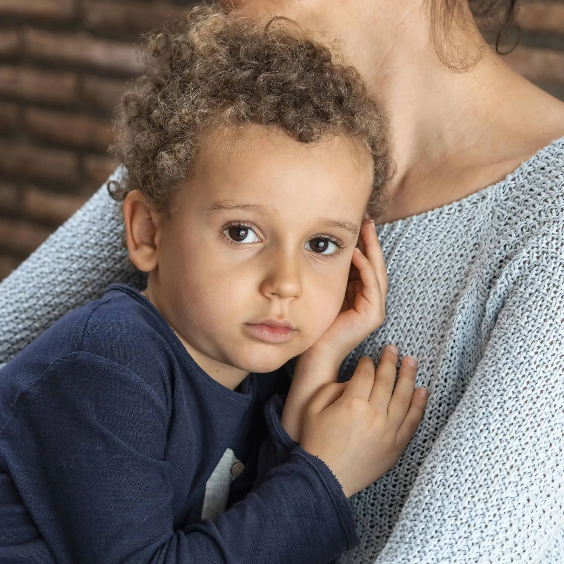 Niño abrazado a su madre